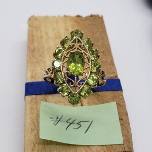 10K gold Cocktail ring in a marquise shape with light green peridot gemstones